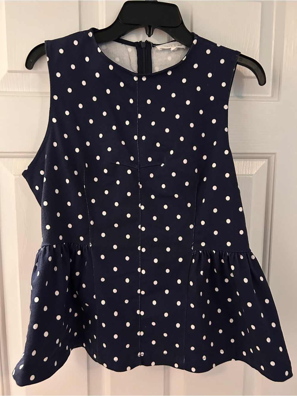 Ladies peplum style navy polka dot top